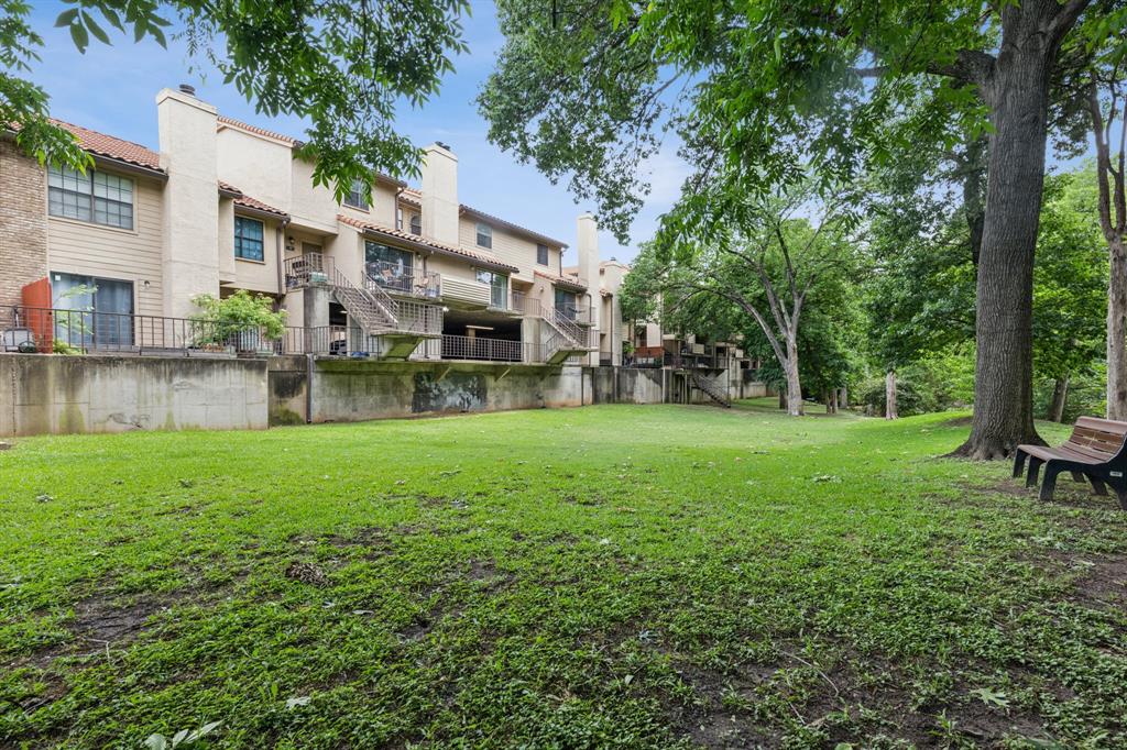 4777 Cedar Springs Road, Unit 6N Dallas, TX 75219 - Photo 23 of 24 a view of a house with a yard and sitting area