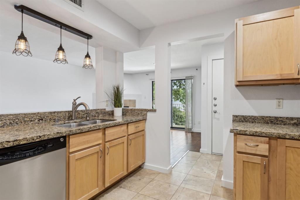 4777 Cedar Springs Road, Unit 6N Dallas, TX 75219 - Photo 3 of 24 a kitchen with granite countertop a sink and cabinets