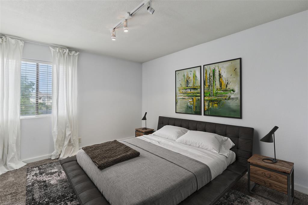 4777 Cedar Springs Road, Unit 6N Dallas, TX 75219 - Photo 4 of 24 a bedroom with a bed and a window