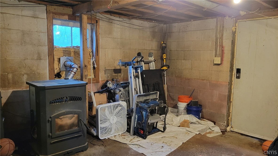 1248 Lake Como Road Summerhill, NY 13045 - Photo 17 of 22 Basement storage and supplemental heating pellet stove. Walkout basement to back yard