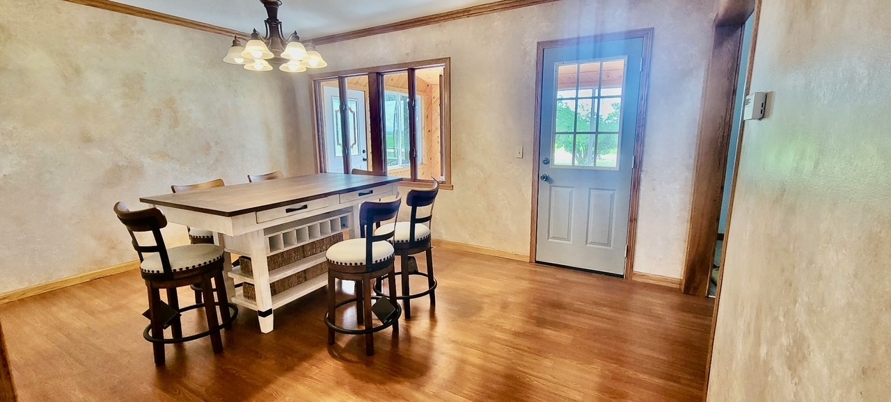 382 Keigwin Road Walnut, IL 61376 - Photo 22 of 49 a view of a dining room with furniture window and wooden floor