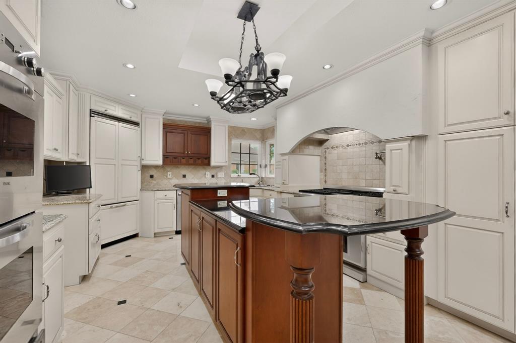2405 Wing Point Lane Plano, TX 75093 - Photo 15 of 39 a kitchen with stainless steel appliances granite countertop a sink a stove a refrigerator and cabinets