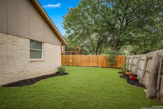 a view of backyard with small cabin