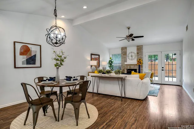 a view of a dining room with furniture wooden floor and a chandelier