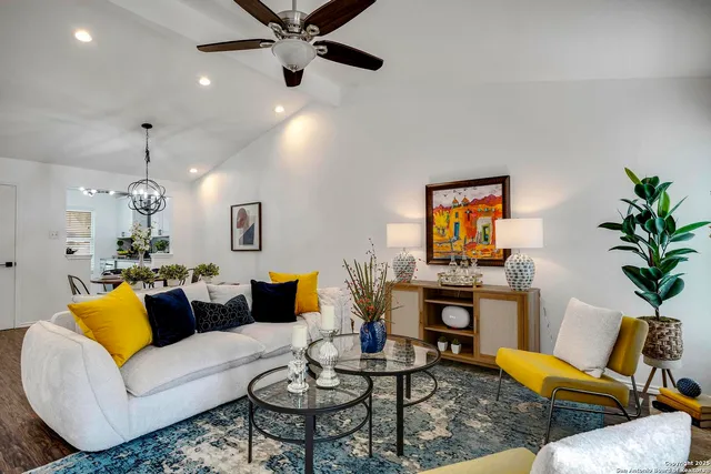 a living room with furniture kitchen view and a fireplace