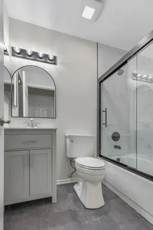a bathroom with a sink a toilet and shower