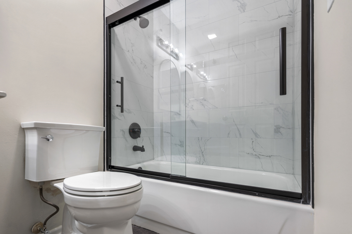 86 Gant Circle, Unit F Streamwood, IL 60107 - Photo 12 of 20 a bathroom with a shower a toilet and a window