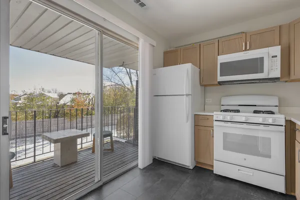 a kitchen with a stove a refrigerator and a cabinets