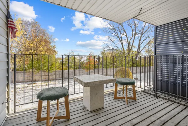 a view of balcony with wooden floor and seating space