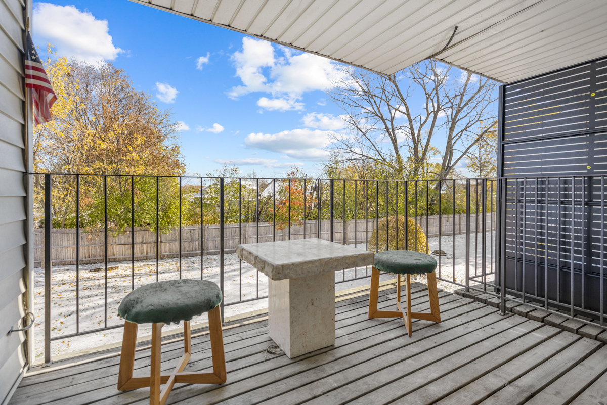 86 Gant Circle, Unit F Streamwood, IL 60107 - Photo 17 of 20 a view of balcony with wooden floor and seating space