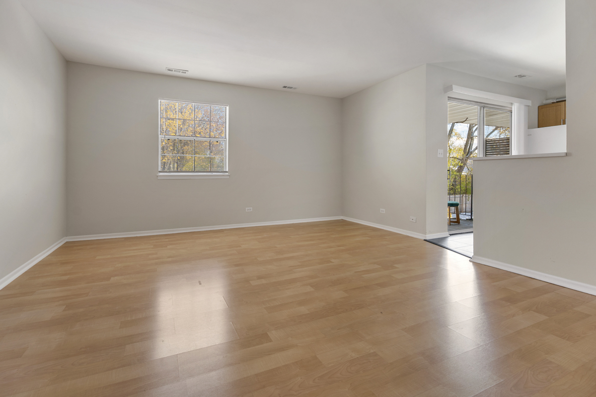 86 Gant Circle, Unit F Streamwood, IL 60107 - Photo 2 of 20 a view of empty room with wooden floor and fan