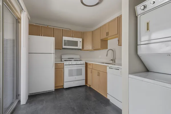 a kitchen with white cabinets and white appliances