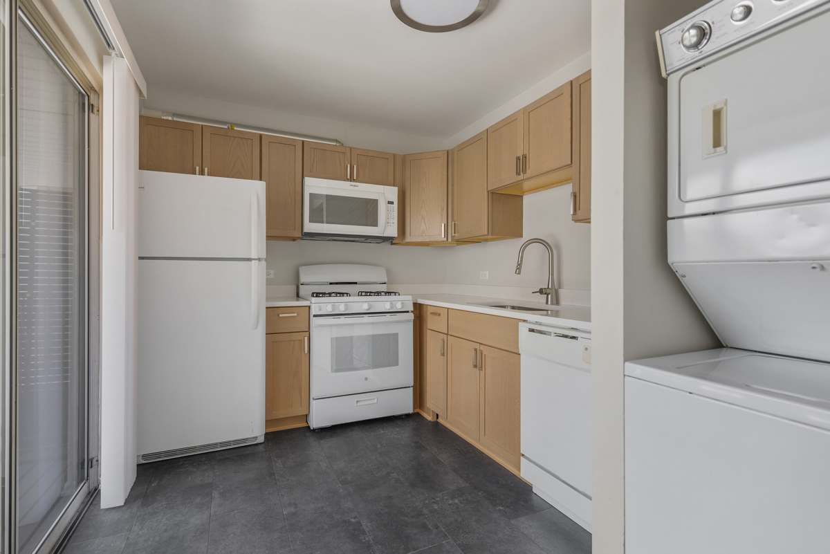 86 Gant Circle, Unit F Streamwood, IL 60107 - Photo 4 of 20 a kitchen with white cabinets and white appliances