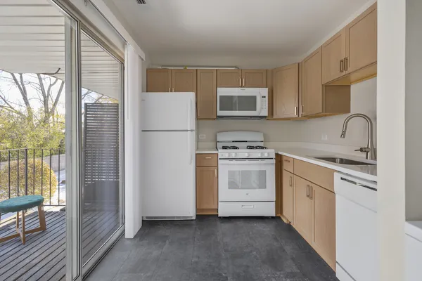 a kitchen with white cabinets and white appliances