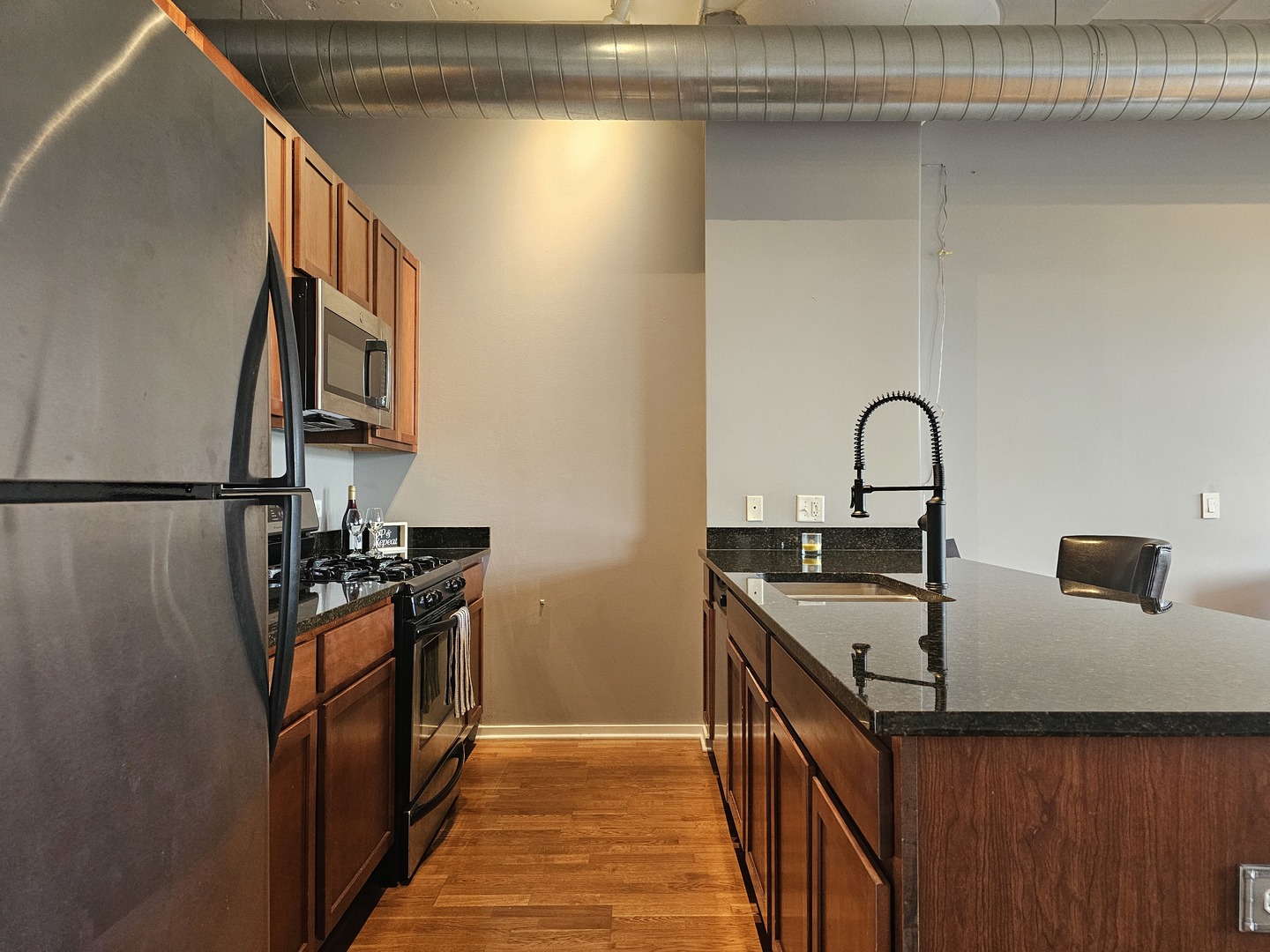 2323 West Pershing Road, Unit 230 Chicago, IL 60609 - Photo 13 of 30 a kitchen with a sink and a stove top oven