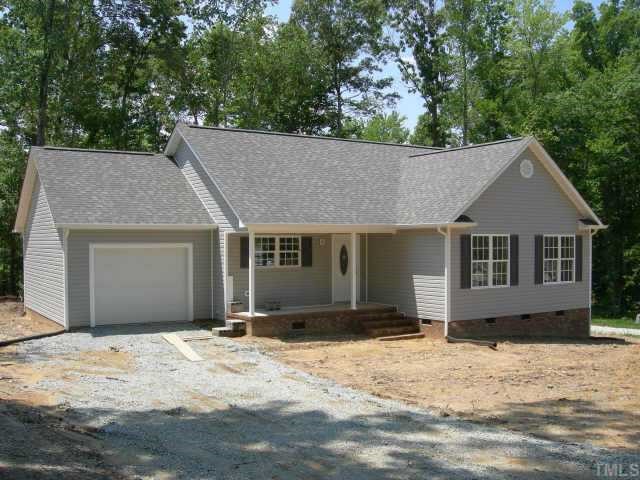 341 Punch Hill Farm Road Rougemont, NC 27572 - Photo 1 of 1 a front view of a house with a yard covered with trees