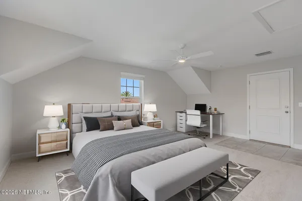 a bedroom with a bed and a couch