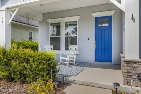 front view of a house with a chairs and table in a patio