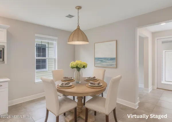 a view of a dining room with furniture and window