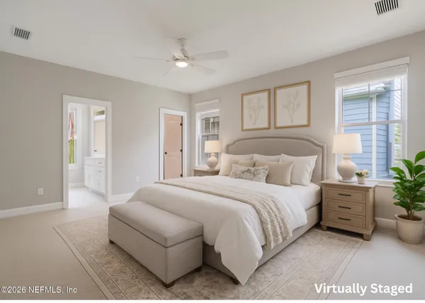 a bedroom with a bed and a potted plant