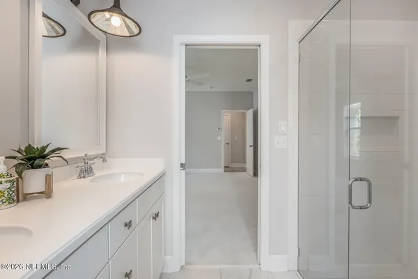 a bathroom with a double vanity sink and mirror