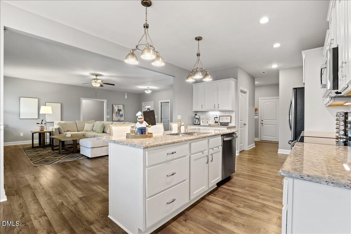 88 Heath Road Lillington, NC 27546 - Photo 35 of 54 a large kitchen with a large counter top appliances and cabinets