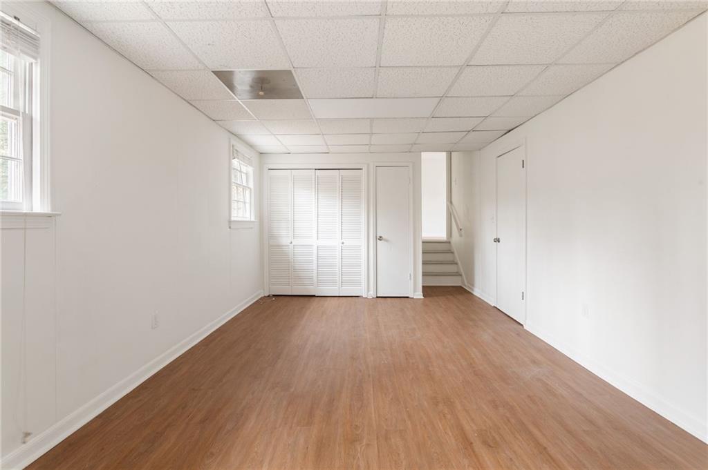 584 Fieldstream Way Northwest Lawrenceville, GA 30044 - Photo 11 of 20 a view of an empty room with wooden floor and a window