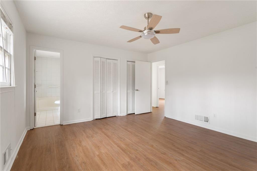 584 Fieldstream Way Northwest Lawrenceville, GA 30044 - Photo 14 of 20 an empty room with wooden floor fan and windows