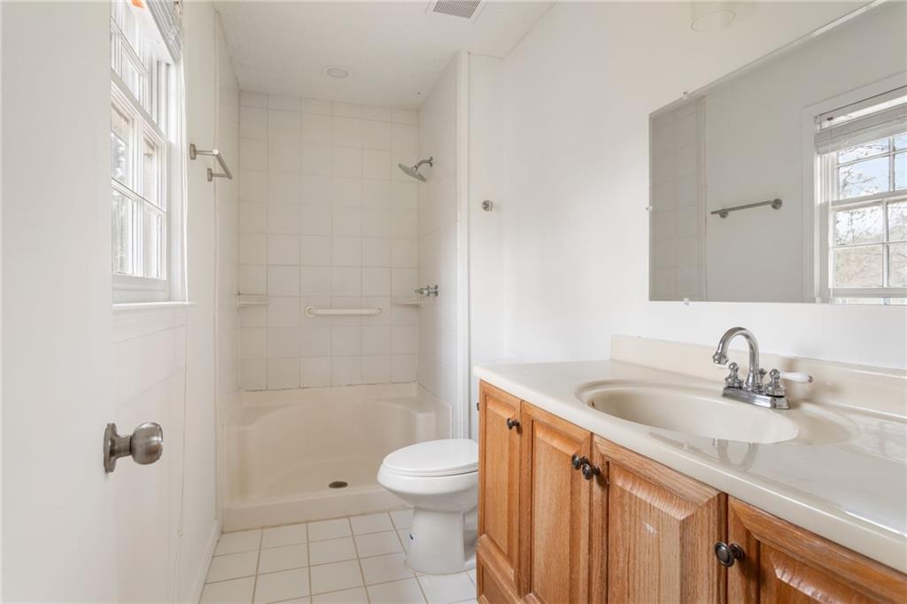 584 Fieldstream Way Northwest Lawrenceville, GA 30044 - Photo 15 of 20 a bathroom with a sink a toilet and shower