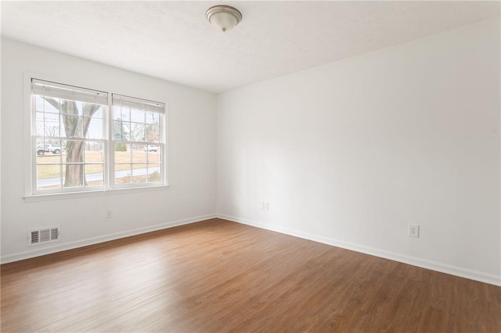 584 Fieldstream Way Northwest Lawrenceville, GA 30044 - Photo 16 of 20 an empty room with wooden floor and windows