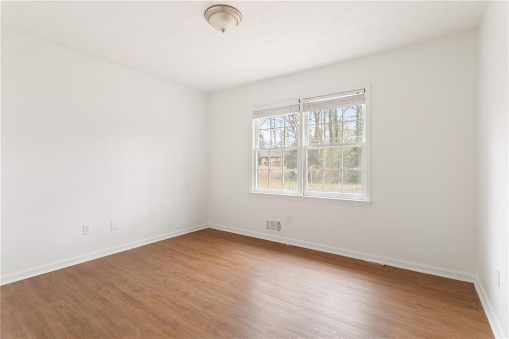 584 Fieldstream Way Northwest Lawrenceville, GA 30044 - Photo 17 of 20 an empty room with wooden floor and windows