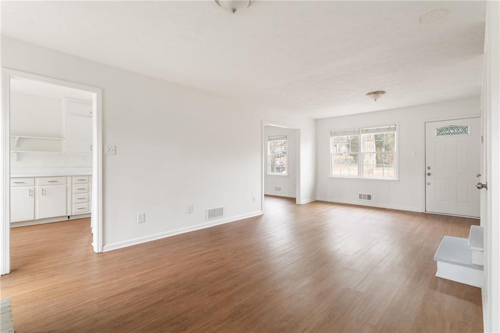 584 Fieldstream Way Northwest Lawrenceville, GA 30044 - Photo 5 of 20 an empty room with wooden floor and windows