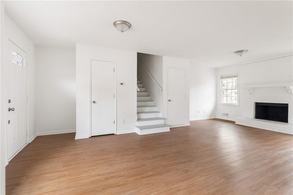 584 Fieldstream Way Northwest Lawrenceville, GA 30044 - Photo 6 of 20 a view of empty room with wooden floor and fireplace