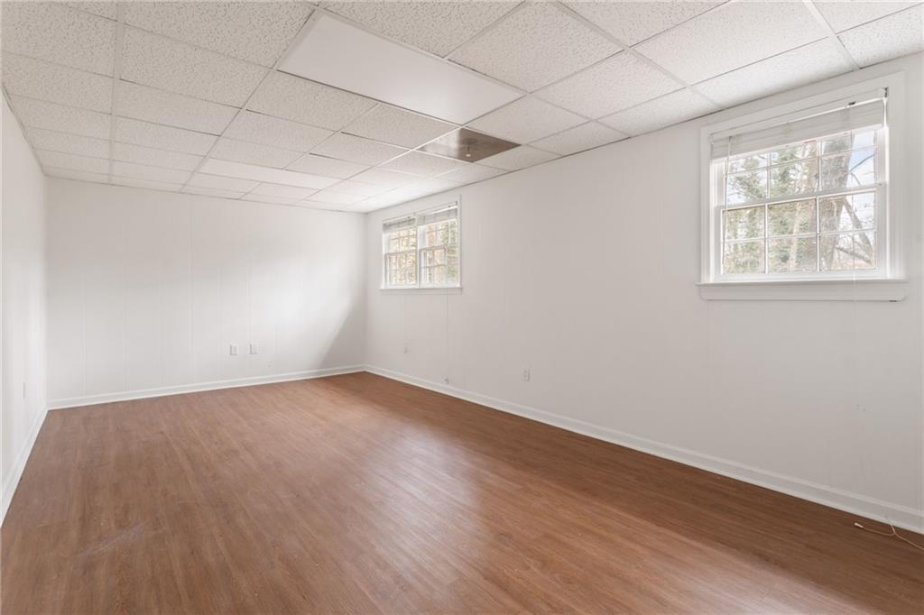 584 Fieldstream Way Northwest Lawrenceville, GA 30044 - Photo 10 of 20 an empty room with wooden floor and windows
