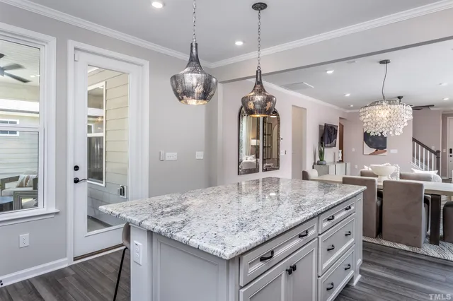 a bathroom with a granite countertop sink and a refrigerator