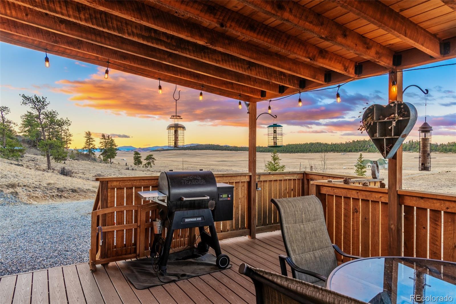189 Goldenburg Canyon Road Hartsel, CO 80449 - Photo 2 of 36 a view of a balcony with furniture and wooden floor