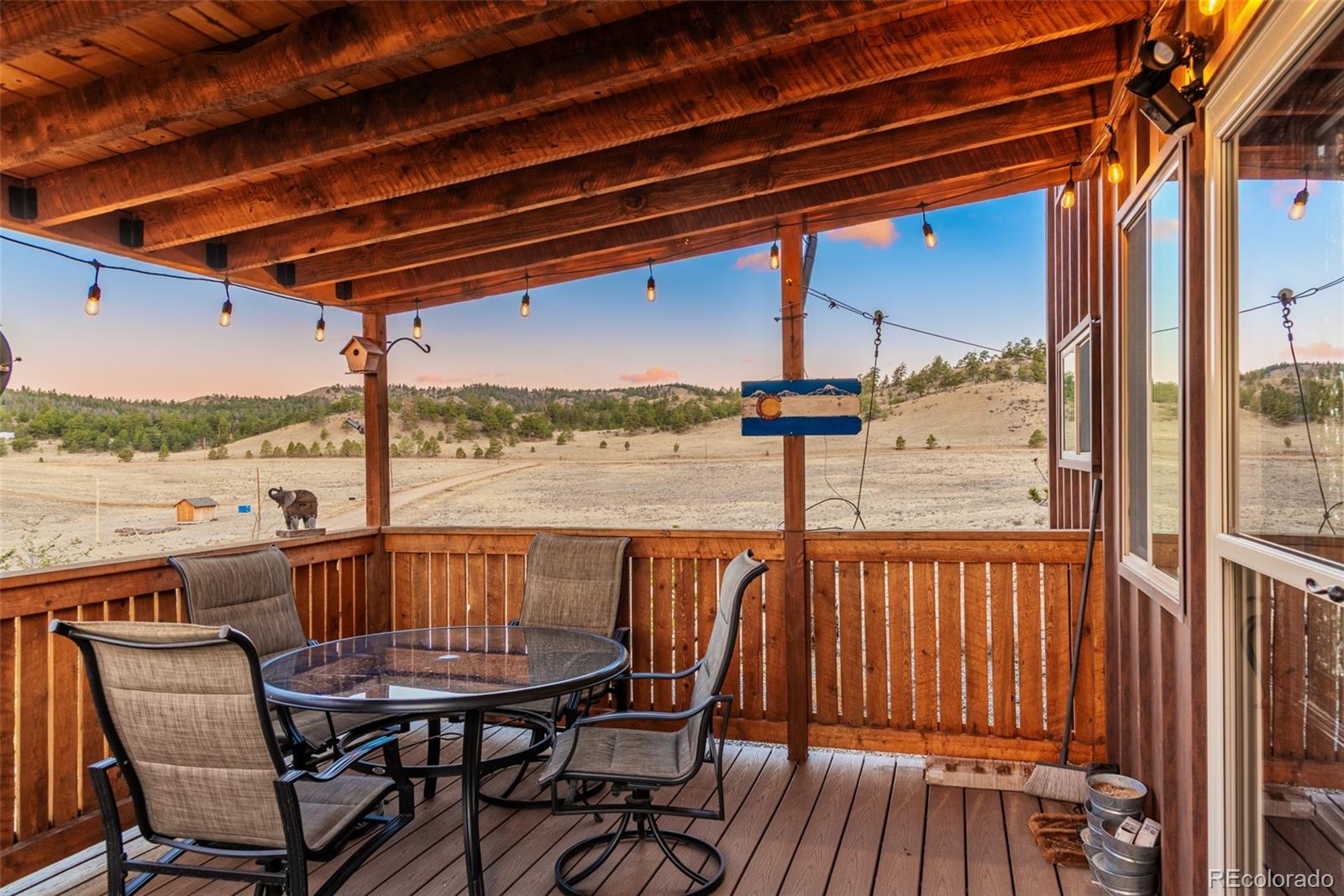 189 Goldenburg Canyon Road Hartsel, CO 80449 - Photo 22 of 36 a view of a chair and table on the deck