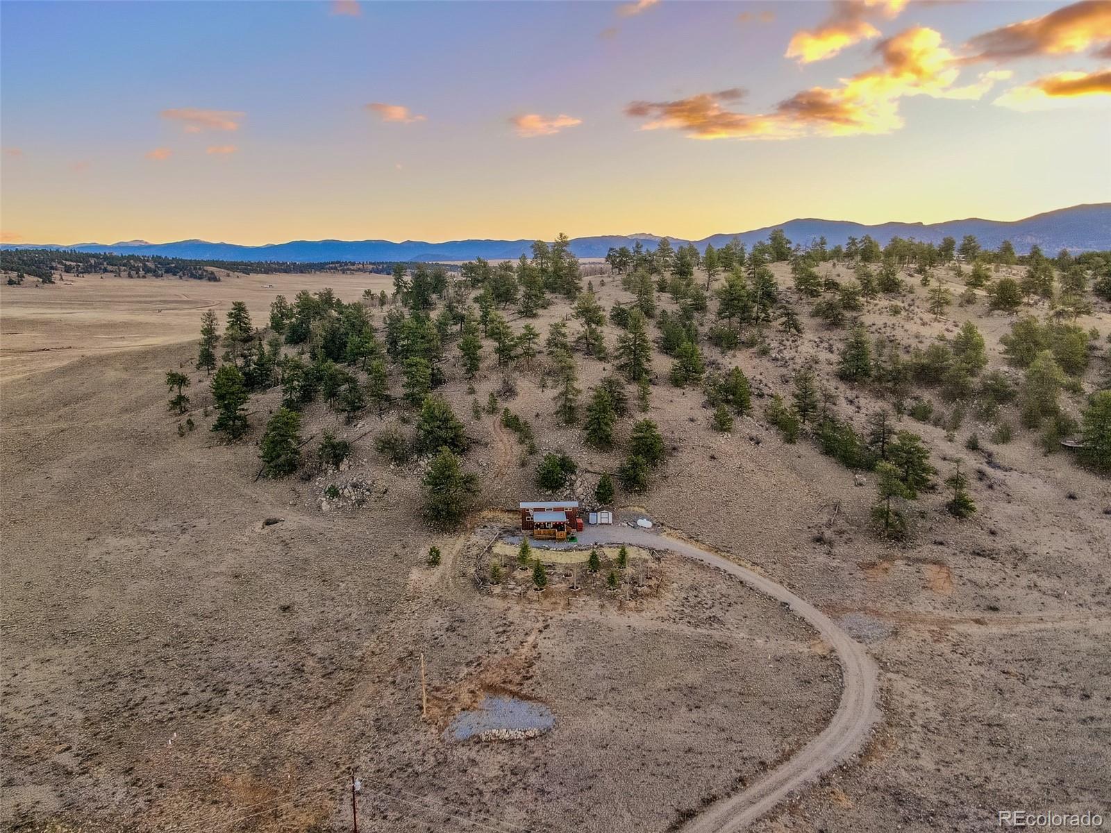 189 Goldenburg Canyon Road Hartsel, CO 80449 - Photo 32 of 36 an aerial view of a house with a yard and lake view