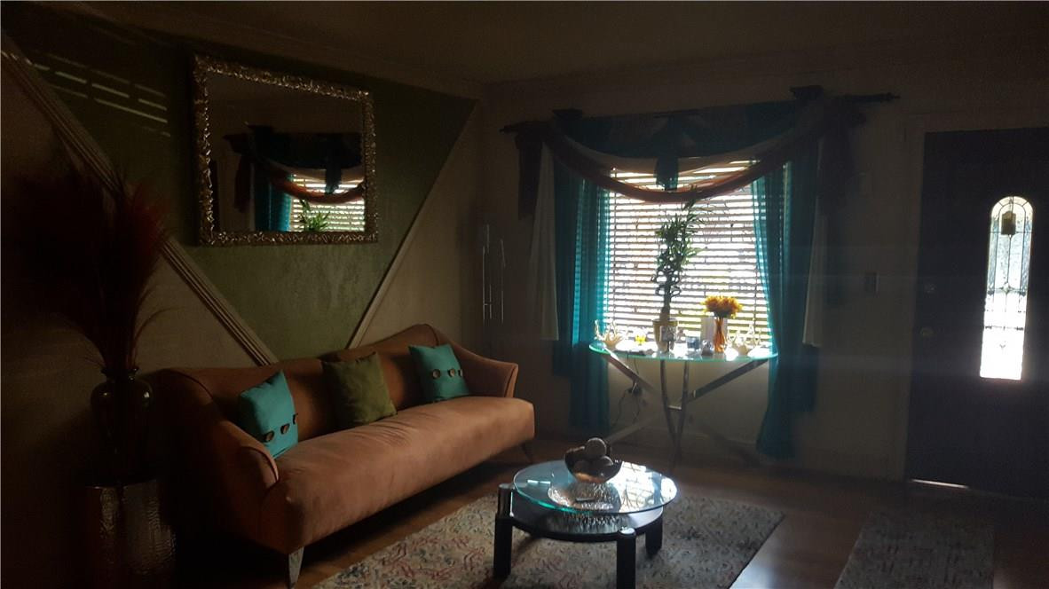 325 Northwest 56th Street Miami, FL 33127 - Photo 4 of 5 a living room with furniture and a window