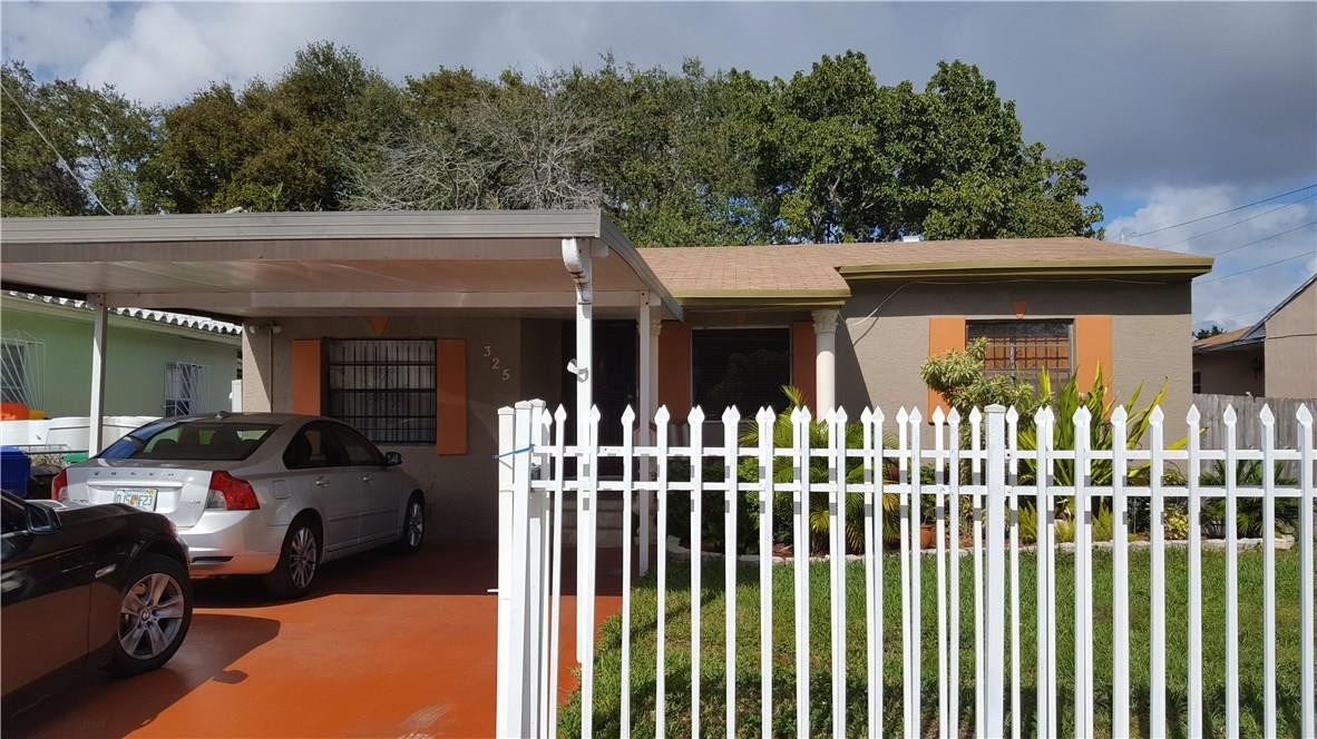325 Northwest 56th Street Miami, FL 33127 - Photo 5 of 5 a view of a house with a small yard and plants