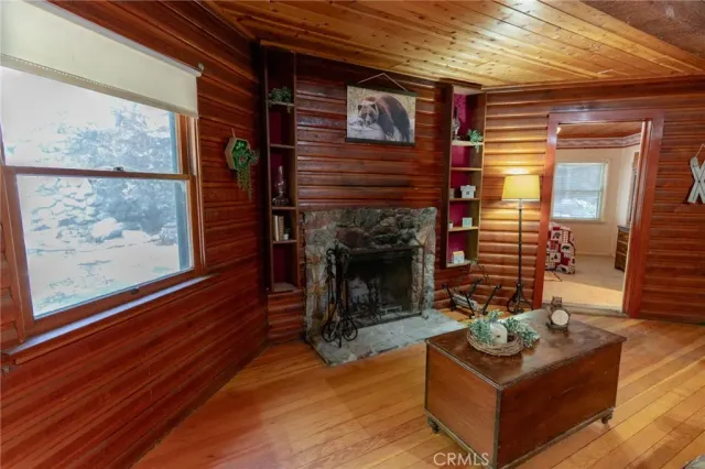a living room with furniture a fireplace and a wooden floor