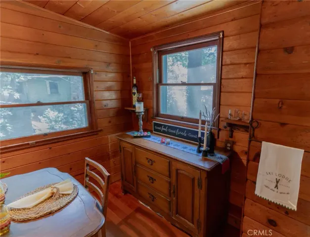 a view of a dining room with furniture large windows and wooden floor