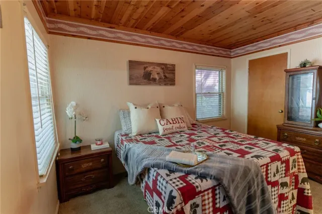 a bedroom with bed and wooden floor