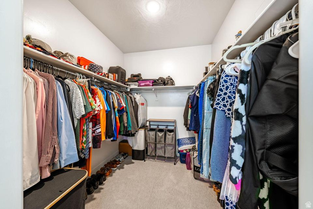 5963 Flattop Drive St. George, UT 84790 - Photo 26 of 45 Walk-in closet featuring carpet flooring, white walls, and built-in shelving with hanging rods