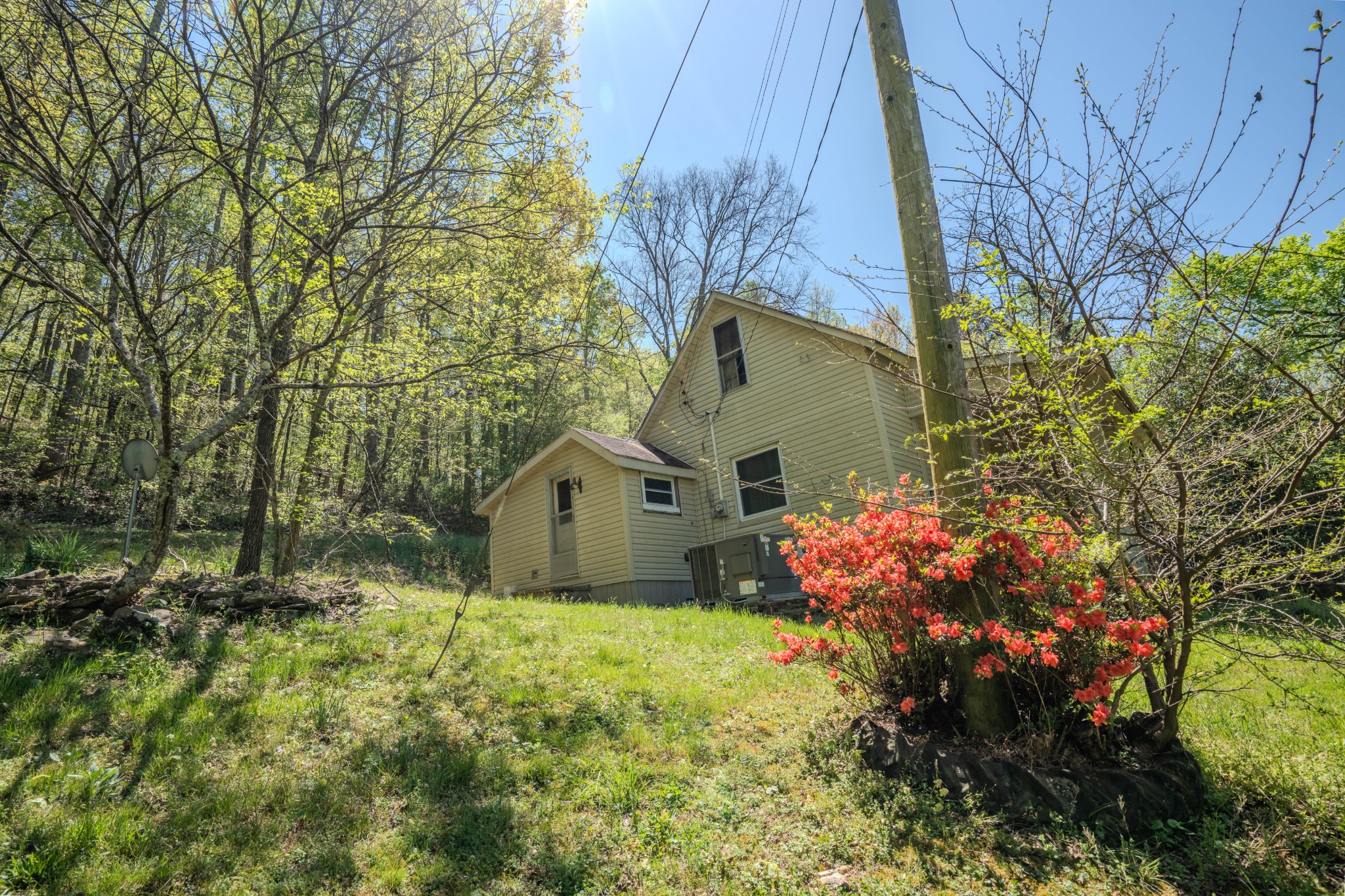 2167 Powdermill Hill Road Lawrenceburg, TN 38464 - Photo 20 of 33 a house is sitting in middle of the green field