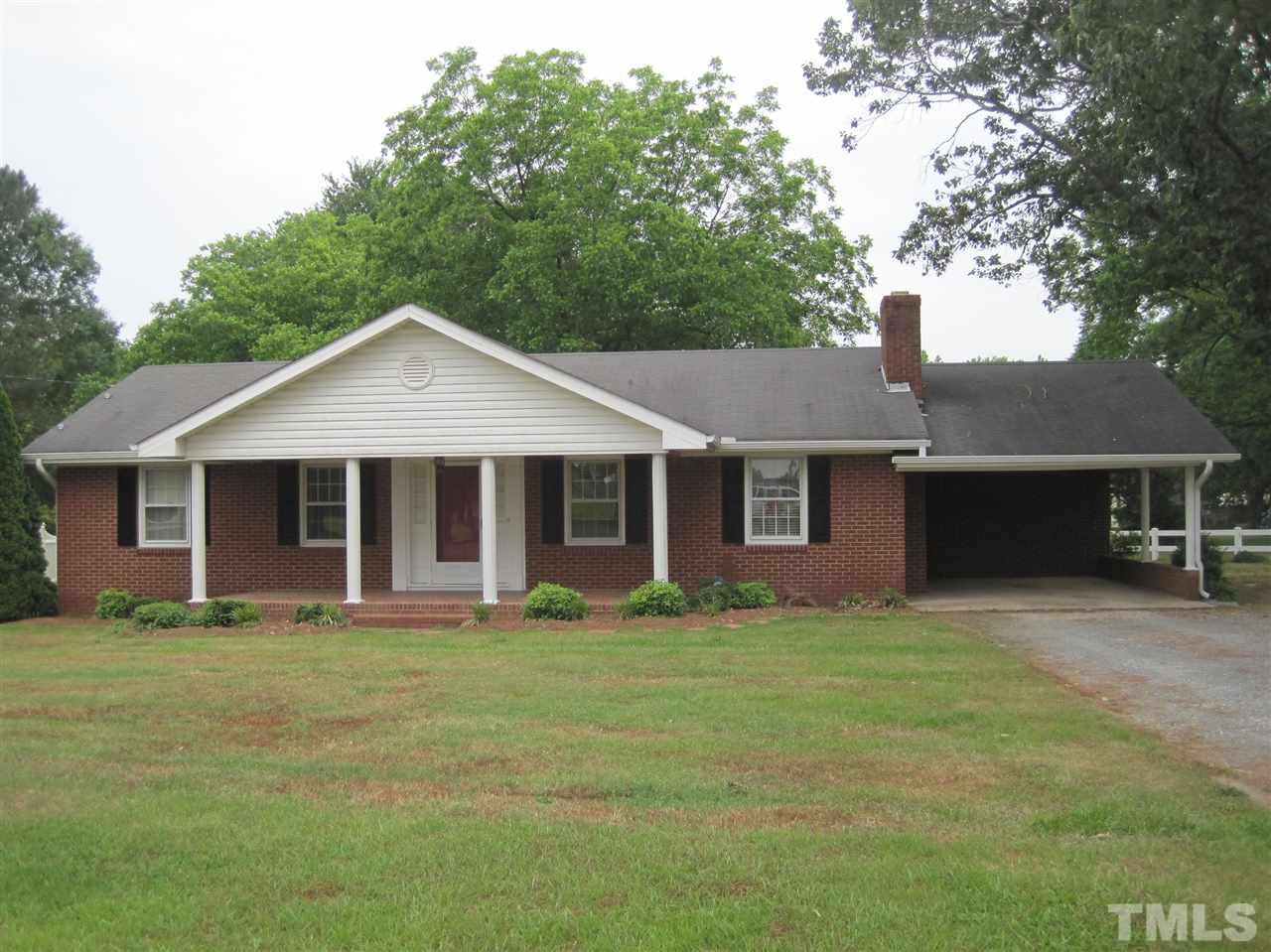 1321 West Core Road Dunn, NC 28334 - Photo 1 of 18 a front view of a house with a yard
