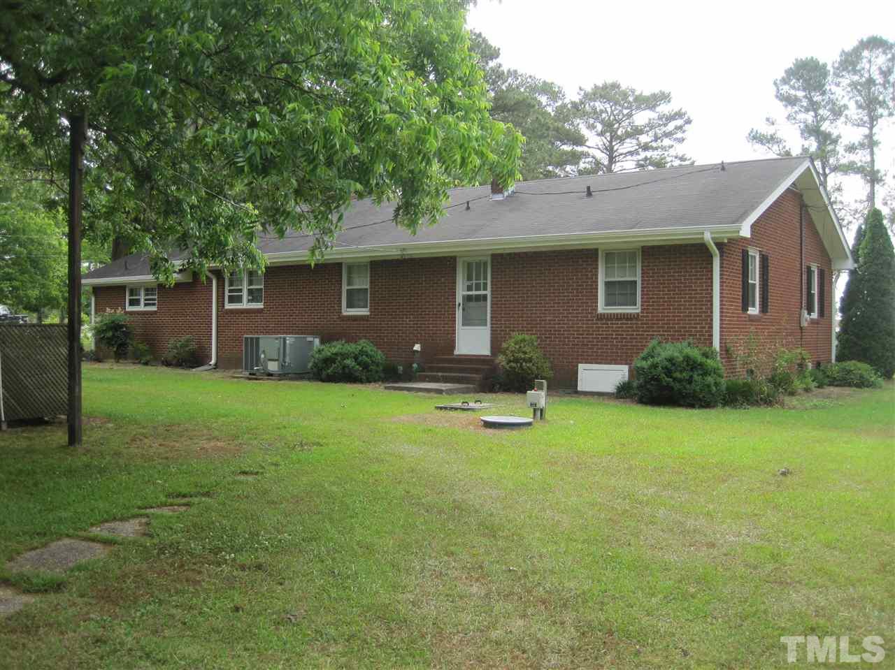 1321 West Core Road Dunn, NC 28334 - Photo 14 of 18 a backyard of a house with table and chairs