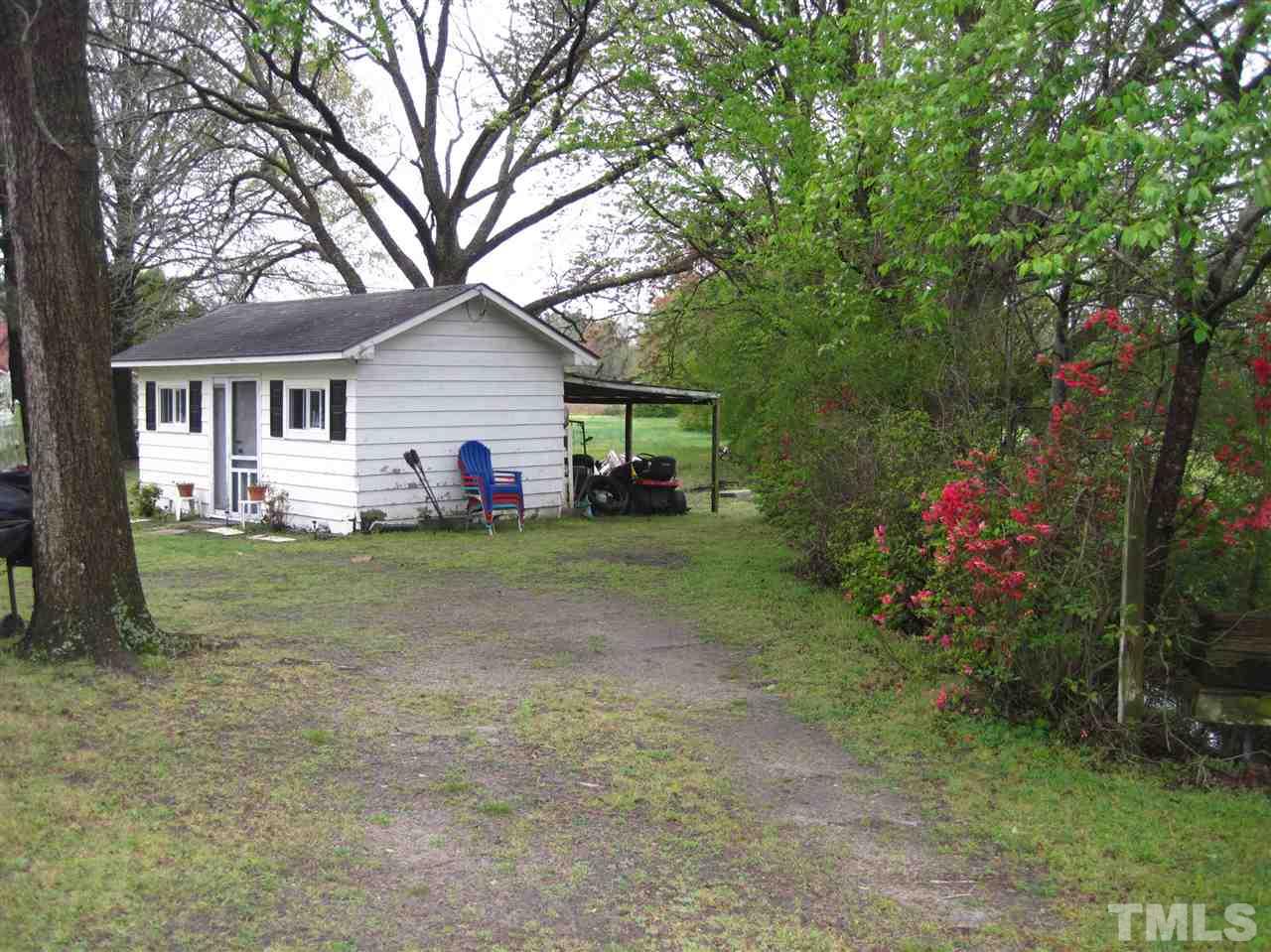 1321 West Core Road Dunn, NC 28334 - Photo 17 of 18 a house view with swimming pool and garden