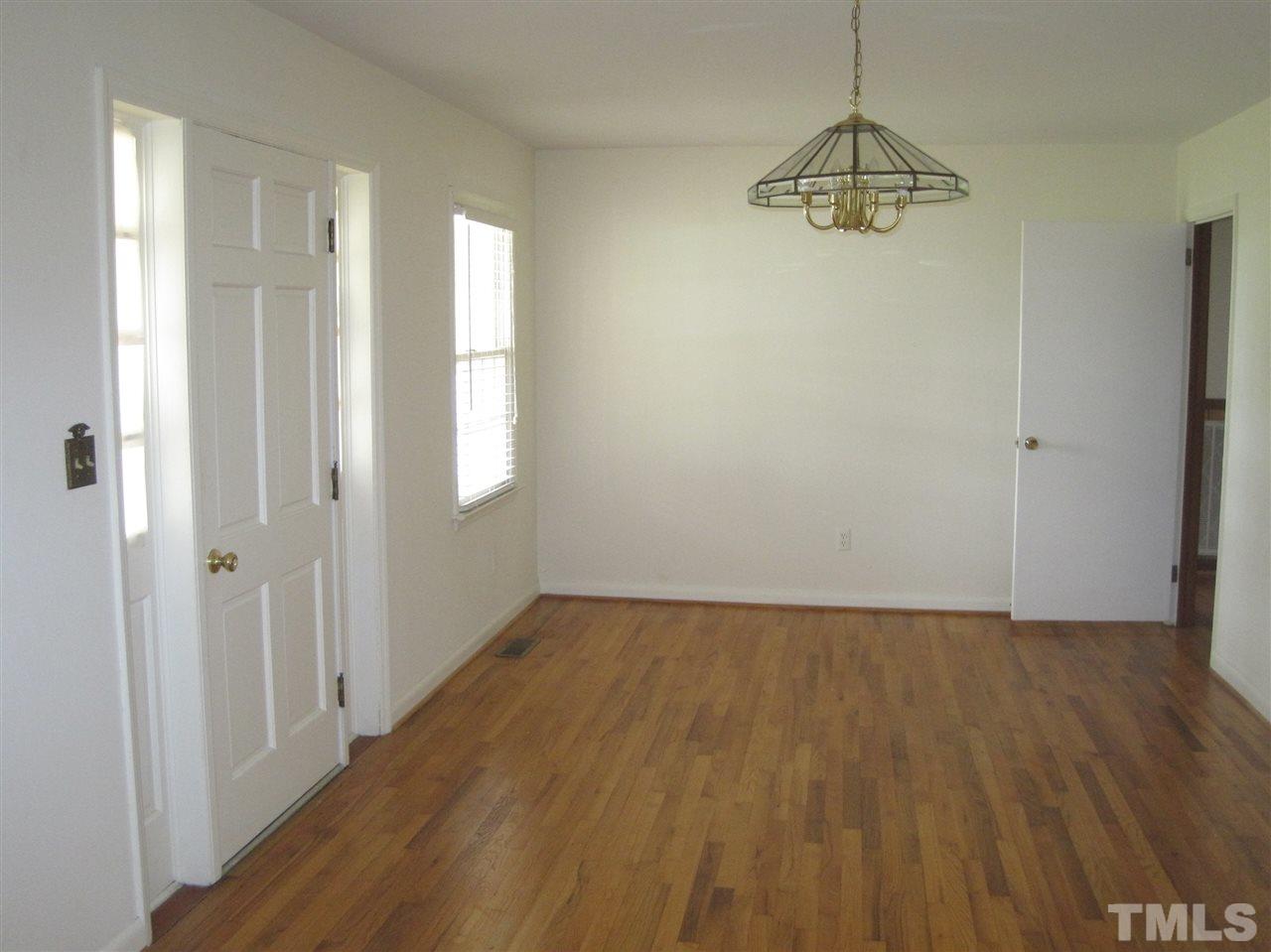 1321 West Core Road Dunn, NC 28334 - Photo 6 of 18 a view of an empty room with wooden floor and window