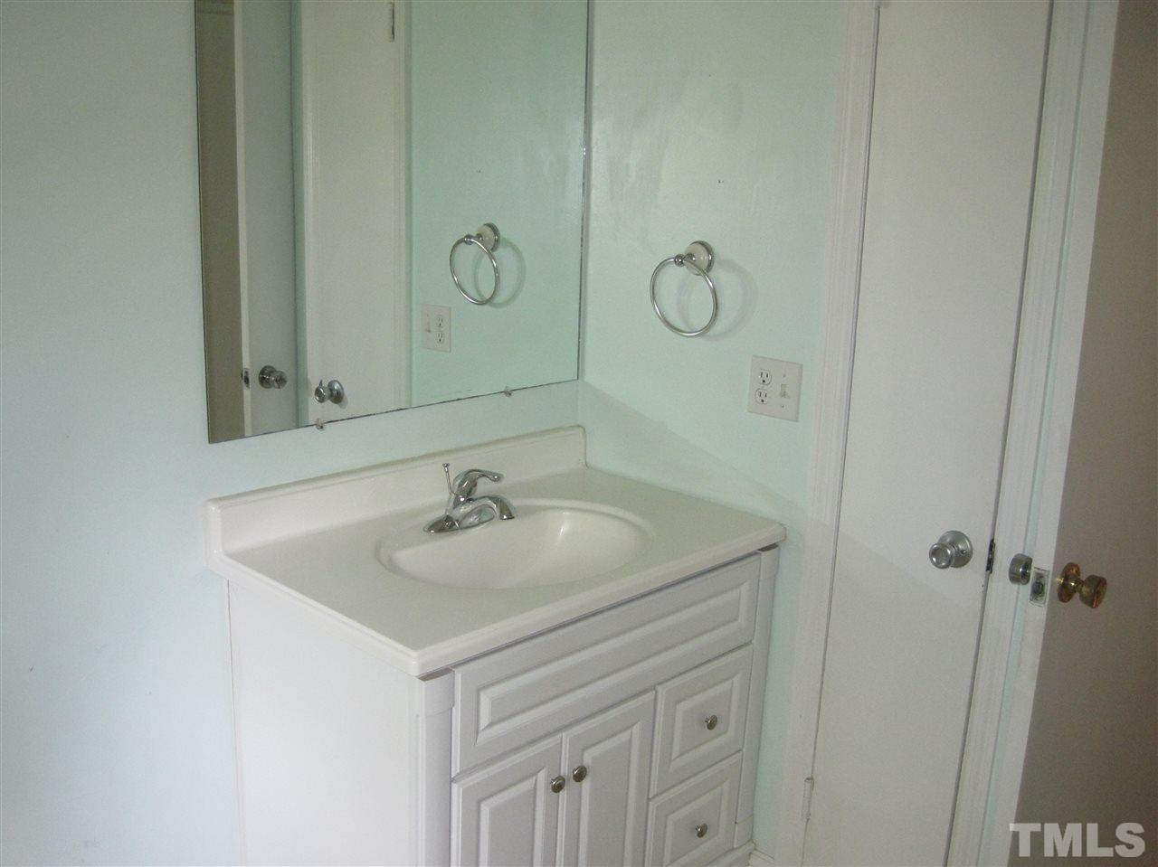 1321 West Core Road Dunn, NC 28334 - Photo 9 of 18 a bathroom with a sink and a mirror